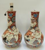 A pair of Japanese large bulbous vases with applied dragon decoration converted to lamps (no drill