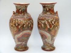 A pair of 19th / early 20thC Japanese Satsuma vases depicting figures with dragon decoration in