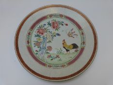 A 19thC Chinese famille rose plate with enamelled decoration of a cockerel,