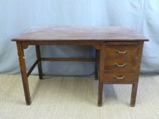 An oak desk, fitted three drawers and slide,