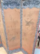 A late 19thC/20thC Japanese silk four-division folding screen with embroidered decoration of cranes