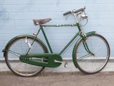 A vintage ladies bicycle with rod brakes