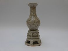 A 19thC Chinese celadon glazed vase with pierced base and raised foliate design,