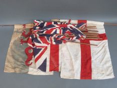 A quantity of vintage hand held union flags together with three larger examples to include a Welsh