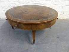 A mahogany inlaid, leather topped drum style coffee table,