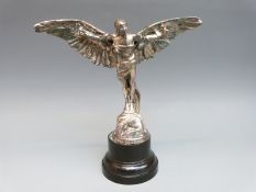 A car mascot formed as Icarus with wings strapped to his arms, marked Finnigans London, 3295,