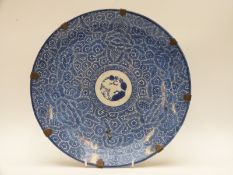 A Chinese blue and white charger with stylised floral decoration,
