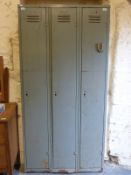 A triple metal locker unit stamped Welconstruct,