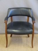 A black leather/leatherette armchair
