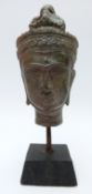 An early Tibetan head on plinth,