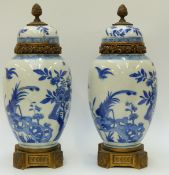 A pair of 18thC/19thC Chinese blue and white Kangxi vases with gilt fittings,