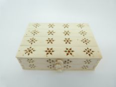An early 20thC ivory cigarette box with pierced floral decoration, 9.2 x 6.5 x 2.
