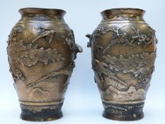 A pair of large Japanese bronze or similar vases with relief decoration of peacocks, 30.
