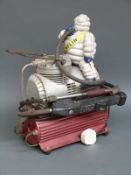 A garage compressor mounted with a Michelin bibendum figure