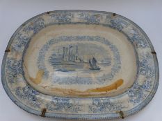 A 19thC blue and white meat plate with central scene of a sailing boat and abbey ruins