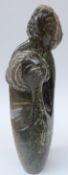 An African Shona green stone carving of a stylised mother and child, signed M Chijumani,
