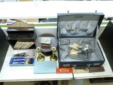 A collection of plated ware including boxed sets, treen tazza, brass candlesticks,