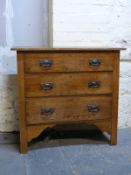 An oak chest of three drawers with Art Nouveau style handles,
