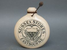 A stoneware small hot water bottle marked Sussex Stores,