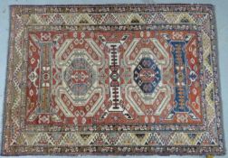 A wool rug with geometric pattern and borders 190 x 136cm