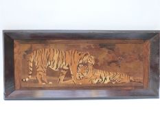 An inlaid wood picture of two tigers,
