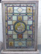 A large oak framed late 19thC window with central circular classical figure and cartouche of flora