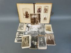 A Victorian Carte Visite album and a collection of loose vintage postcards including stage and