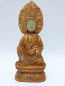 A Chinese jadeite style model of Guanyin decorated in a gilt,