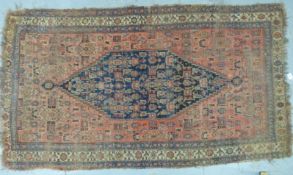A 19thC/20thC Persian carpet with central blue gul,