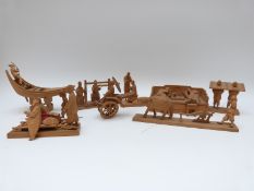 A collection of Chinese carved wood figures depicting everyday scenes including weaving,