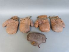 Two pairs of vintage leather boxing gloves together with a single 4oz example
