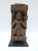 A 19thC Napalese carved wooden fragment on stand,