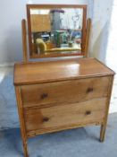 An oak two drawer dressing chest with mirror above,