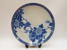 A Japanese large blue and white charger decorated with birds and flowers, impressed mark to base,