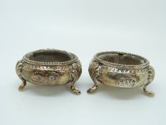 A pair of Chinese white metal three footed open salts with Chinese marks,