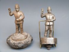 Two policeman car mascots, one on a radiator cap,