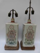 A pair of Chinese famille rose rectangular bottle vases on wooden bases,