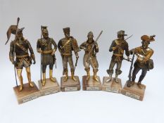 Six painted and gilt cast metal continental soldiers on named hardstone bases,