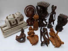 A collection of Indonesian, Indian and Balinese wood carvings of women and deities,