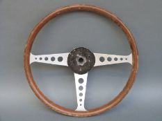 A vintage wood rimmed aluminium steering wheel,