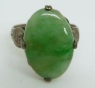 A Chinese silver ring set with a jadeite cabochon,