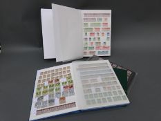 A stockbook of mint GB stamps and two stockbooks of used stamps, Victoria - QEII,