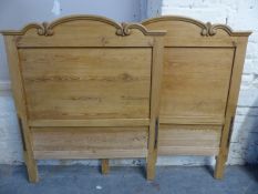A pair of pine single sleigh type beds