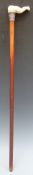 An Indian malacca walking stick with carved ivory handle depicting a woman's naked legs and bottom,