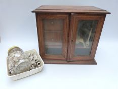 An inlaid oak smoker's cabinet with two drawers and glazed doors together with a large quantity of