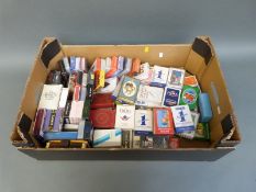 A collection of approximately 70 packs of playing cards to include Grants Whiskey,