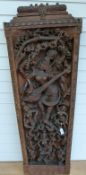 A Tibetan heavily carved panel depicting the God of Music,