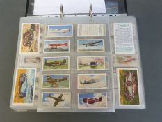 A collector's folder containing a large collection of cigarette cards,