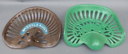 Two cast iron tractor or implement seats, one W.M Doyle & Co.