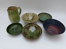 Six pieces of studio pottery including five bowls / dishes and a jug,